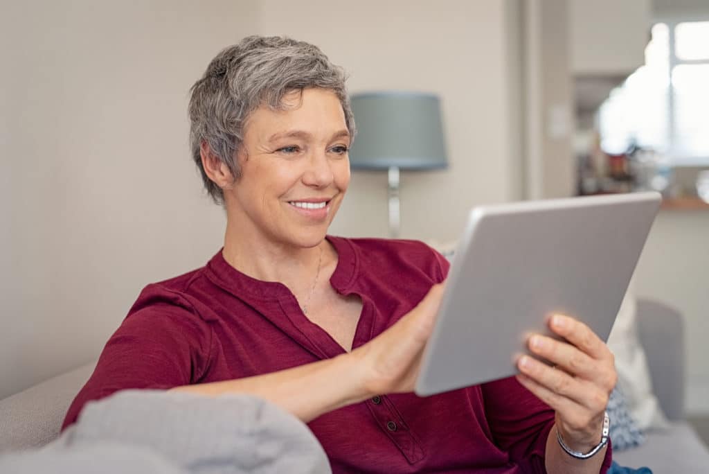 Woman Looking at Dental Websites | Medicare Plan Finder