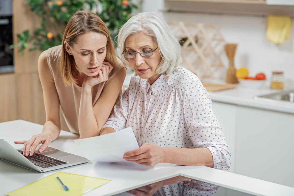 Caregiver Discussing Power of Attorney With Senior Woman | Medicare Plan Finder