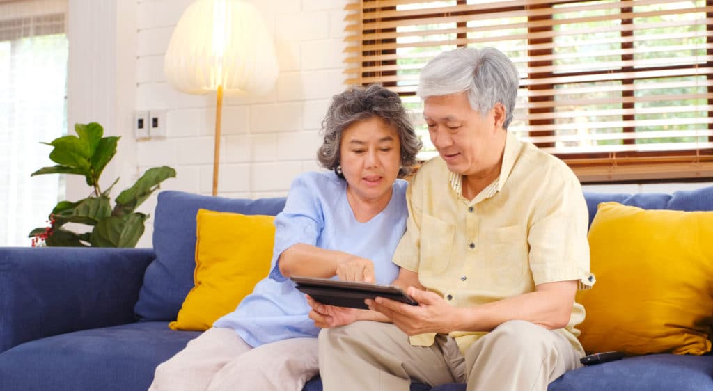 Couple Learning About Glucose Monitoring on Tablet - Medicare Plan Finder
