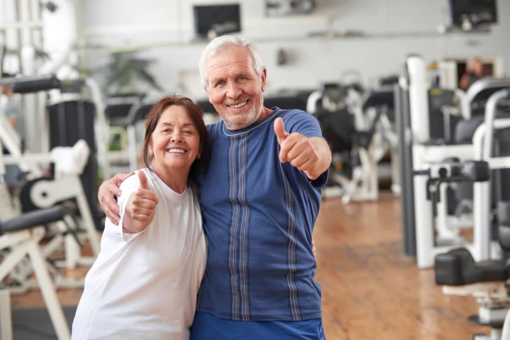 Happy Couple Staying Active at the Gym - Medicare Plan Finder